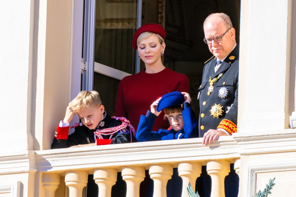 Prince Albert of Monaco, in military uniform, Princess Grace and their children Princess Gabriella and Prince Jacques on a balcony.